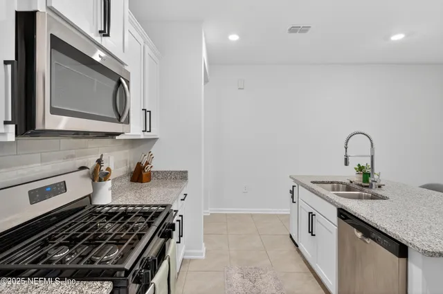 a kitchen with a stove and cabinets
