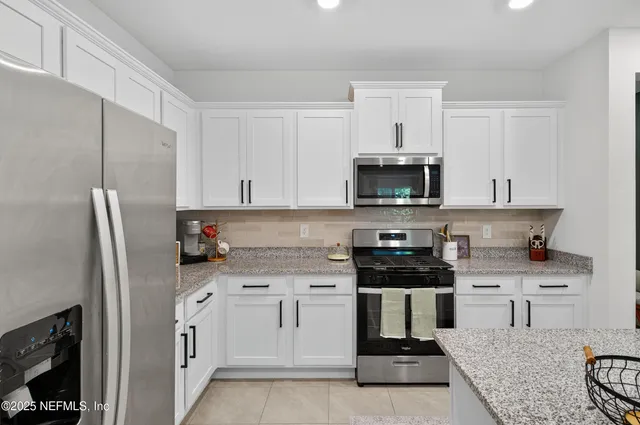 a bedroom with a bed flat screen tv and a large window