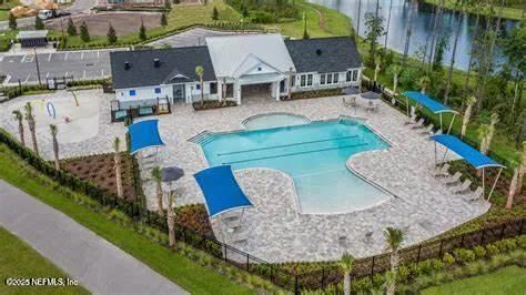 an aerial view of a house with garden space and street view