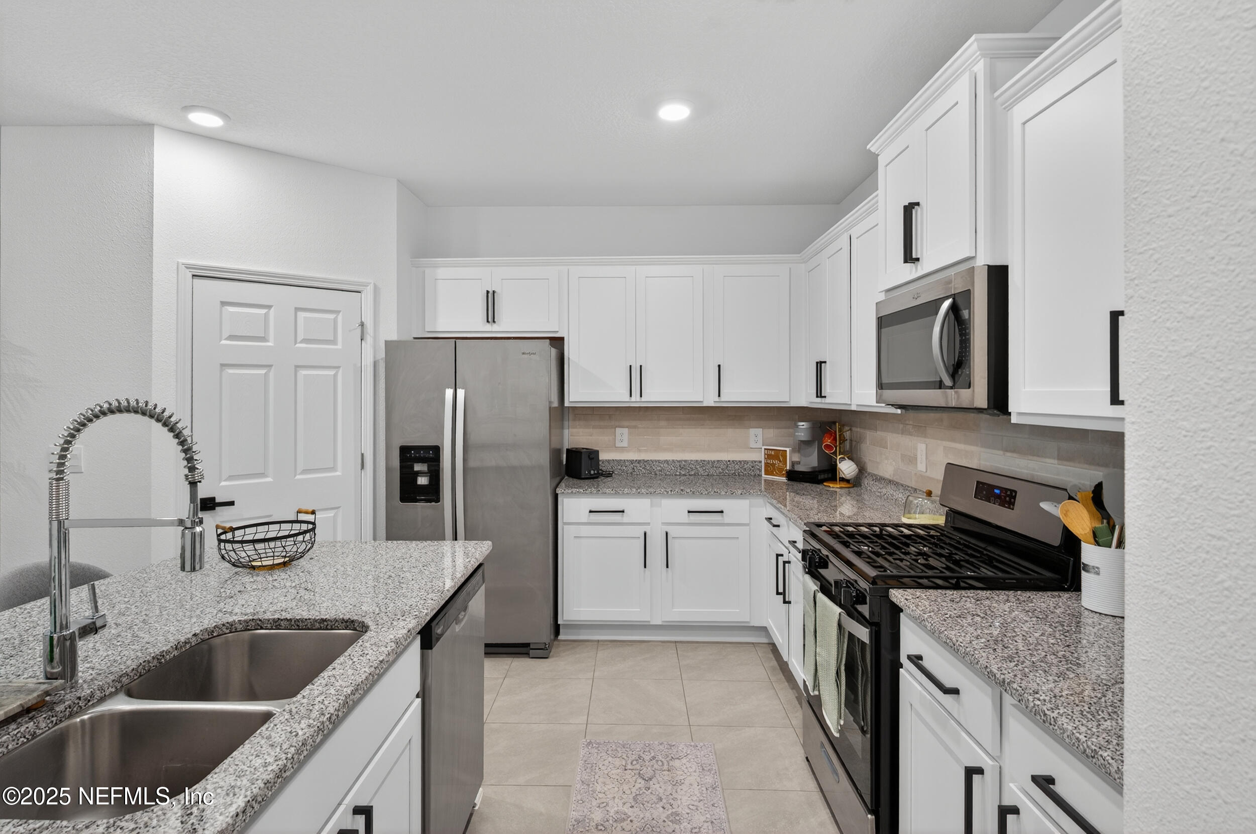 33 Coastline Way St. Augustine, FL 32092 - Photo 26 of 35 a kitchen with a sink stove top oven and refrigerator
