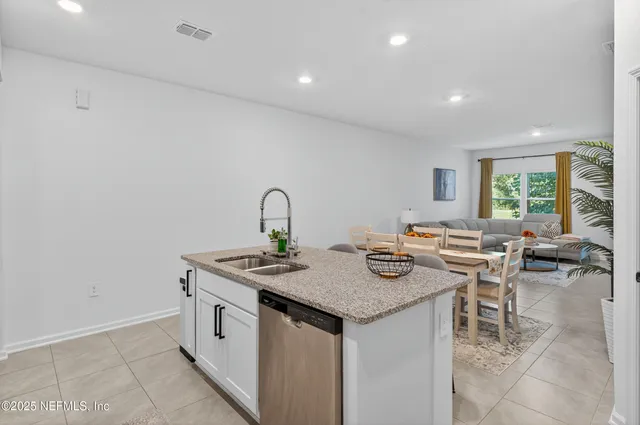 a living room with furniture and floor to ceiling windows