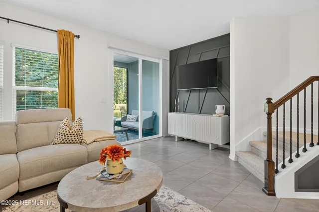a living room with furniture and kitchen view