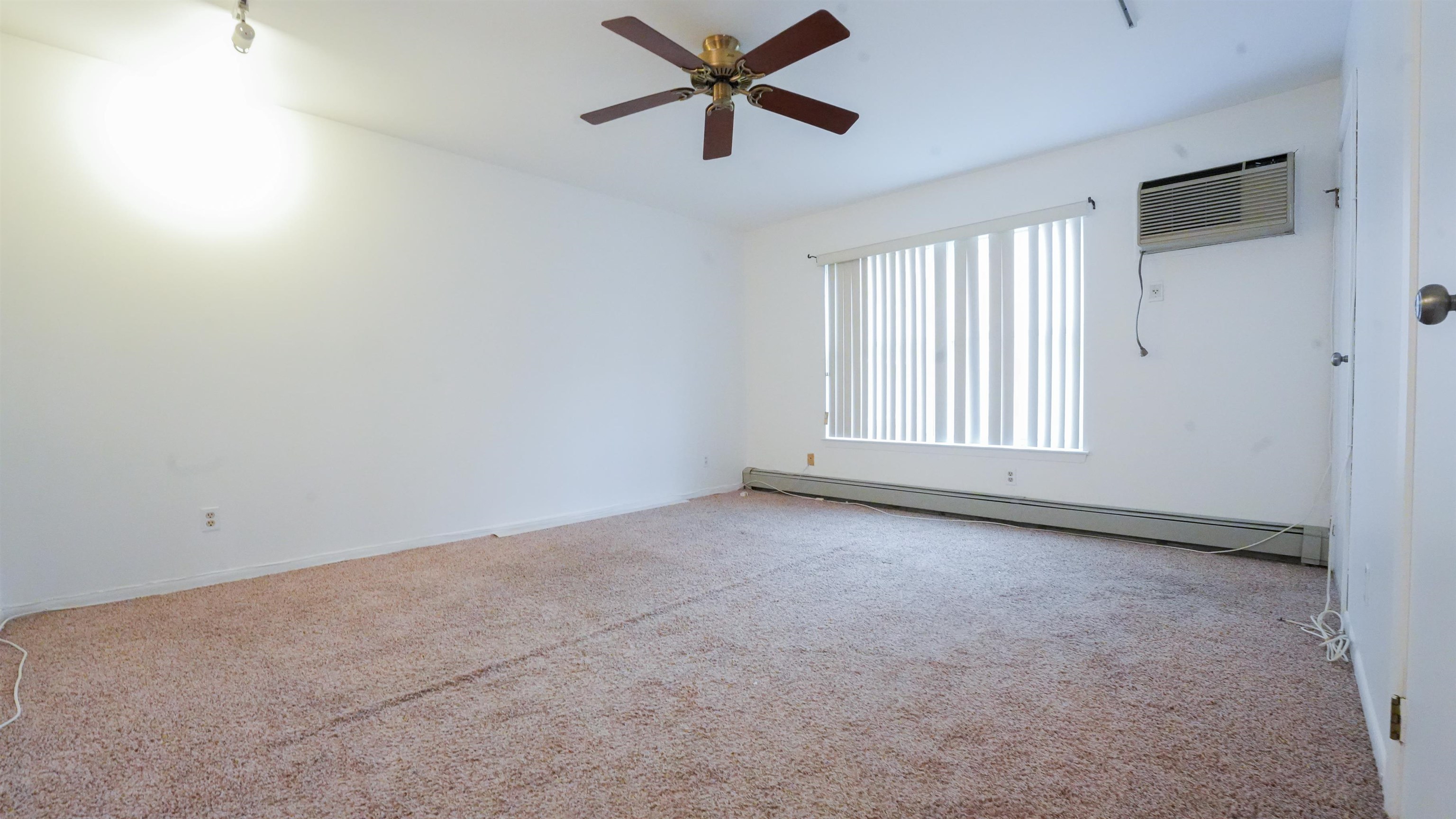 24 Riverview Court, Unit 24 Secaucus, NJ 07094 - Photo 17 of 25 an empty room with window and a ceiling fan