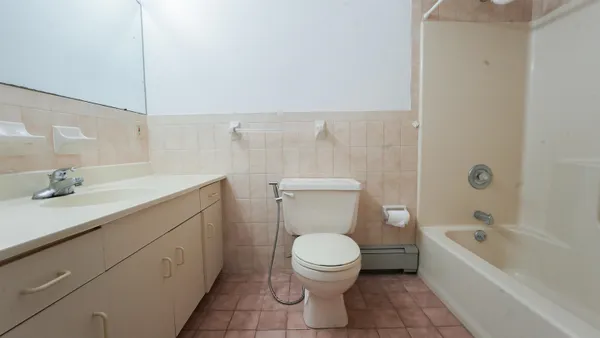 a bathroom with a toilet and a bathtub