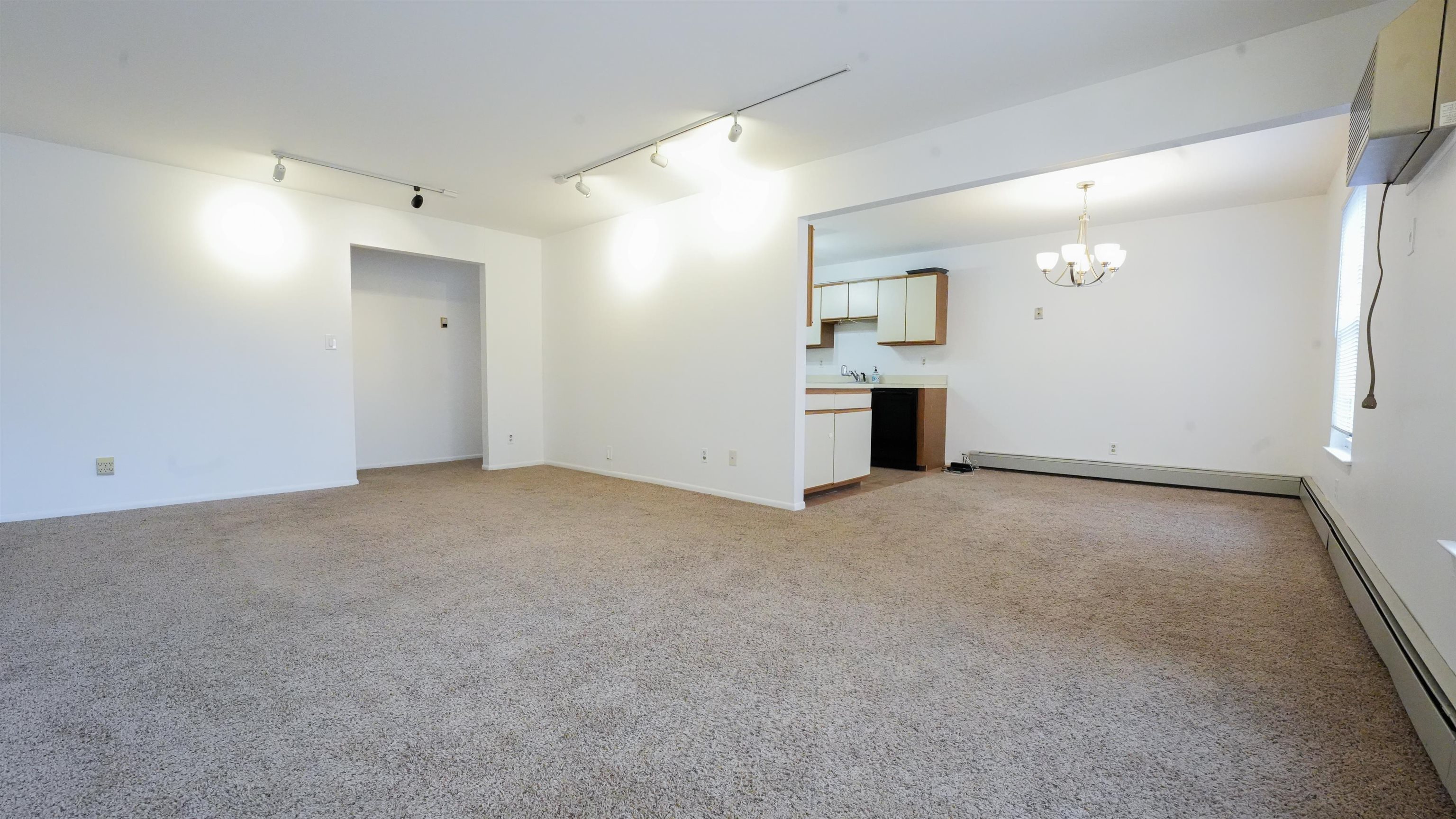24 Riverview Court, Unit 24 Secaucus, NJ 07094 - Photo 3 of 25 an empty room with windows and cabinet