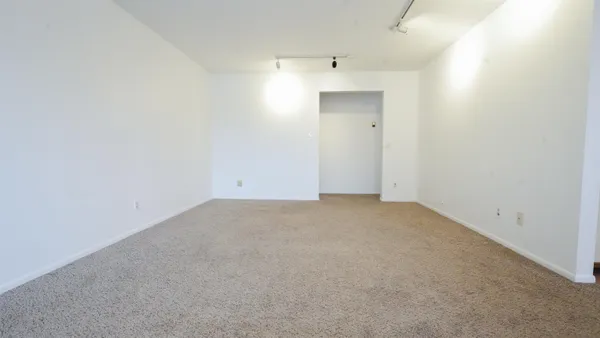 a view of a kitchen with a sink a dishwasher cabinets and a window