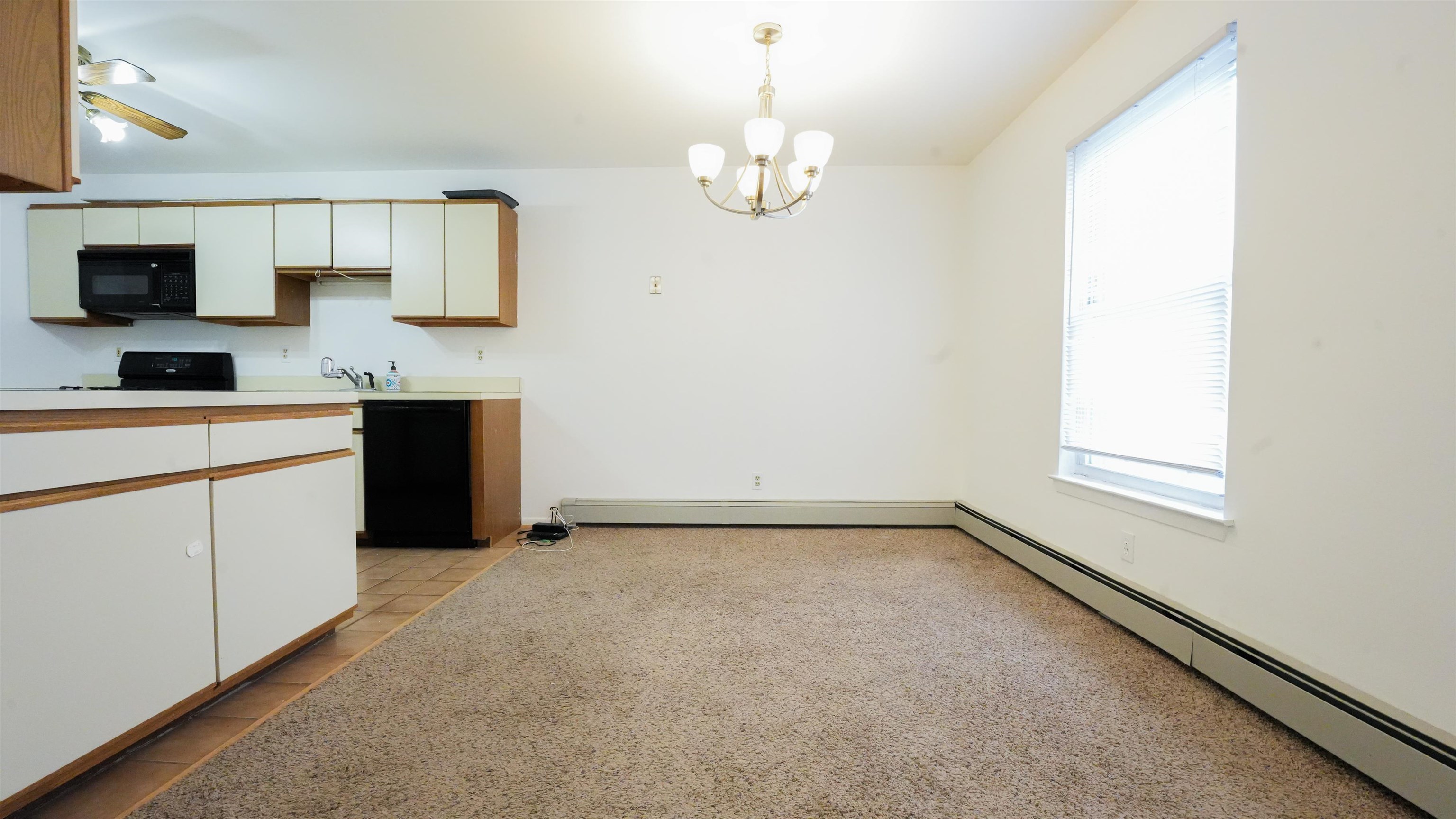 24 Riverview Court, Unit 24 Secaucus, NJ 07094 - Photo 5 of 25 a view of a kitchen with a sink a dishwasher cabinets and a window