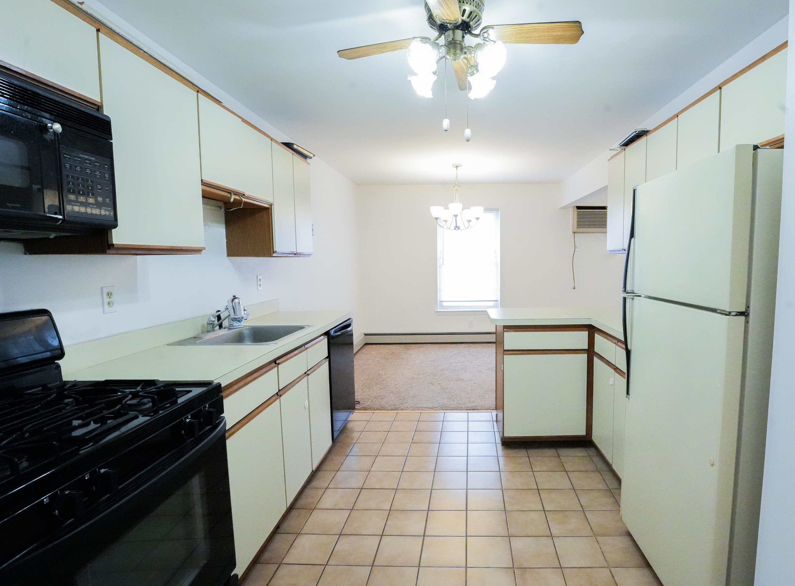 24 Riverview Court, Unit 24 Secaucus, NJ 07094 - Photo 8 of 25 a kitchen with a refrigerator a sink and a stove