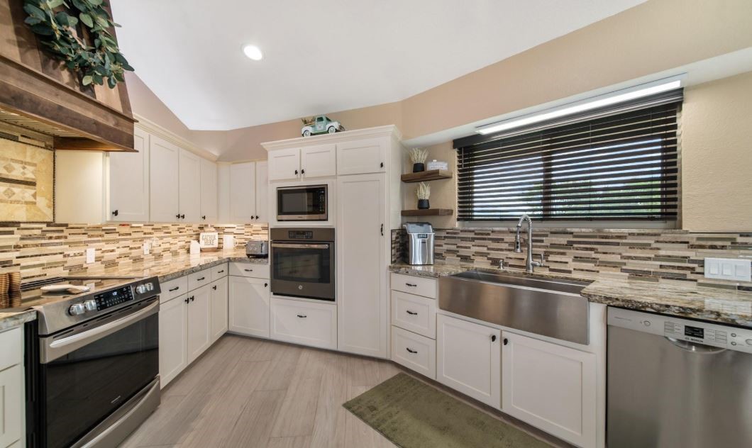 6714 Spray Lane, Unit C699A Rosharon, TX 77583 - Photo 28 of 48 Kitchen Remodeled August 2023 with Custom Cabinetry & Granite Counters. Notice the Gorgeous Vent Hood!