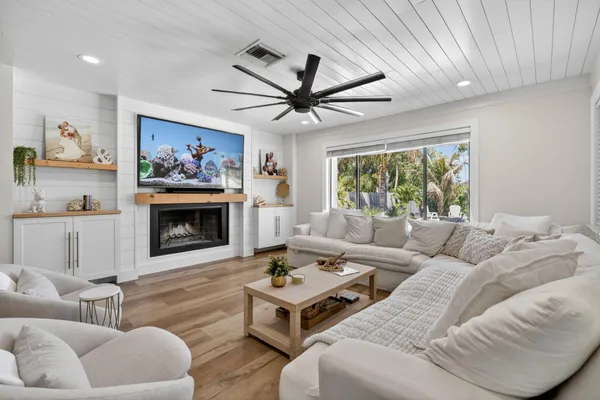 a large kitchen with kitchen island a large counter top space a sink stainless steel appliances and cabinets