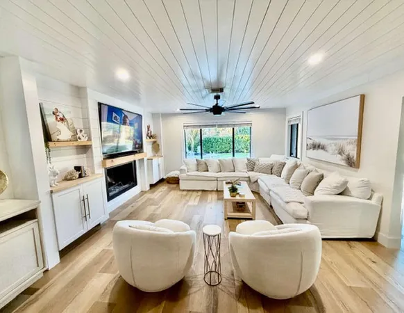 a kitchen with stainless steel appliances a table chairs refrigerator and cabinets