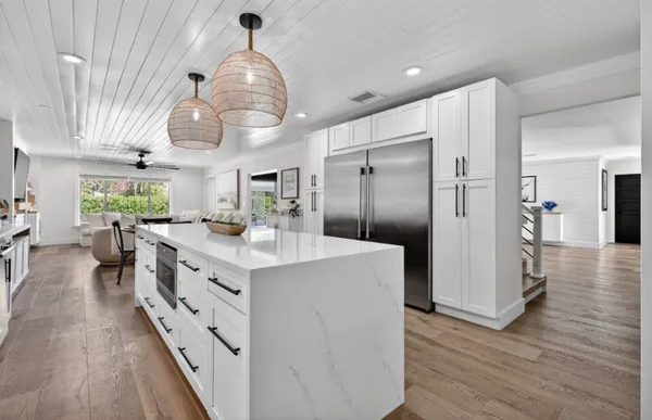 a kitchen with cabinets and wooden floor