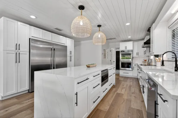 a kitchen with a stove and cabinets