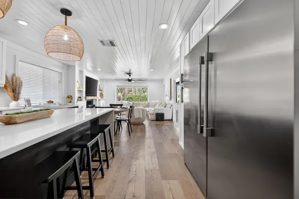 a view of a livingroom with a ceiling fan and a large window