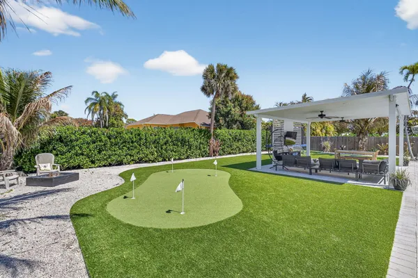 an aerial view of a house with a yard and lake view