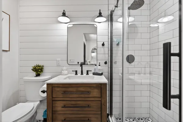 a kitchen with stainless steel appliances a dining table chairs and chandelier