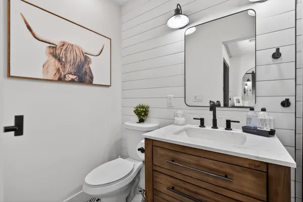 a kitchen with stainless steel appliances a table chairs refrigerator and chandelier