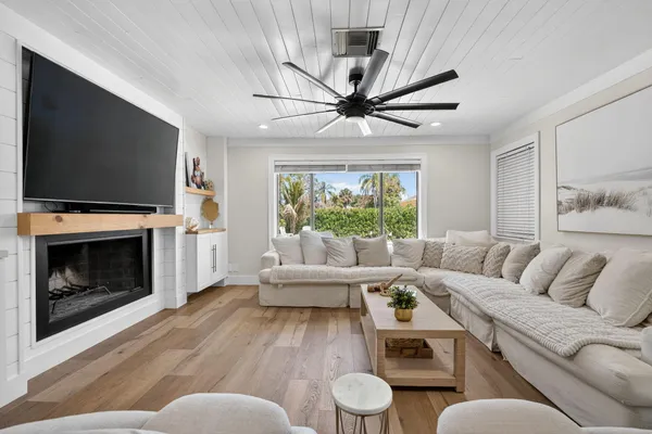 a large kitchen with stainless steel appliances a large counter top a sink and a refrigerator