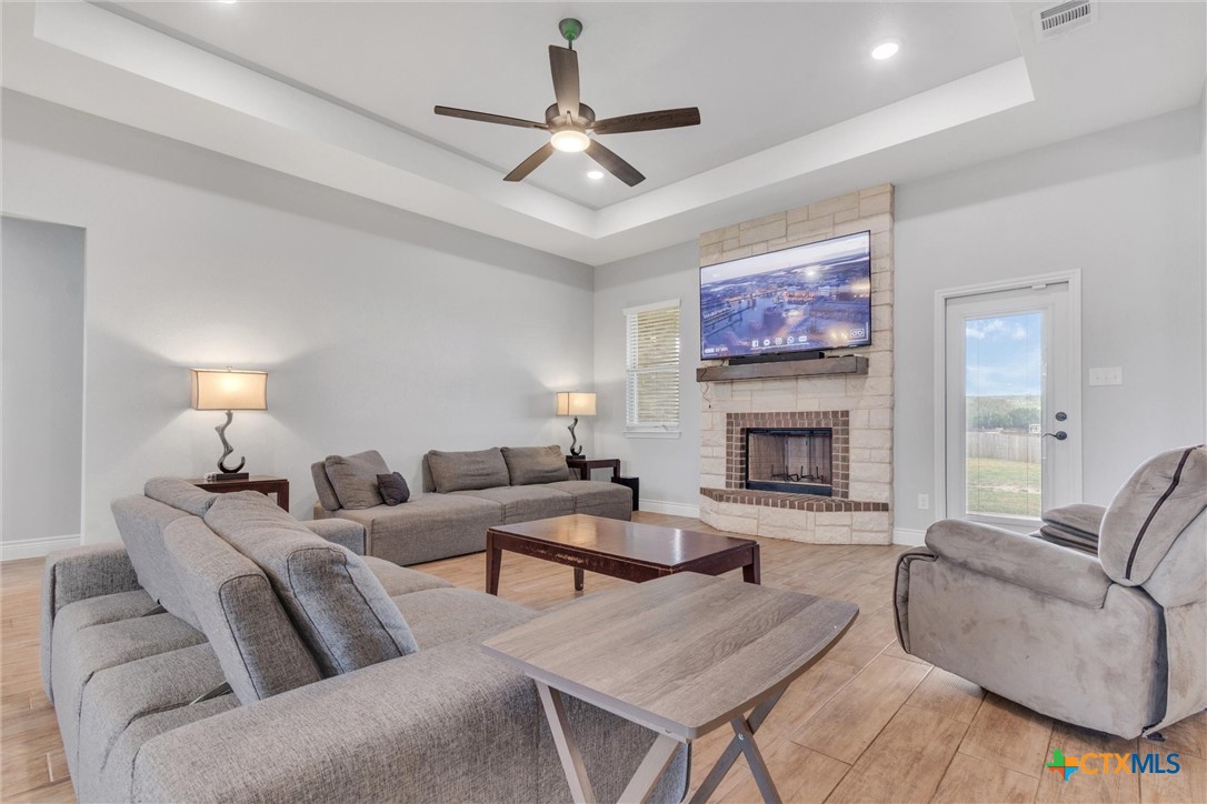 3919 Gracey Lane Kempner, TX 76539 - Photo 9 of 44 a living room with furniture a fireplace and a flat screen tv