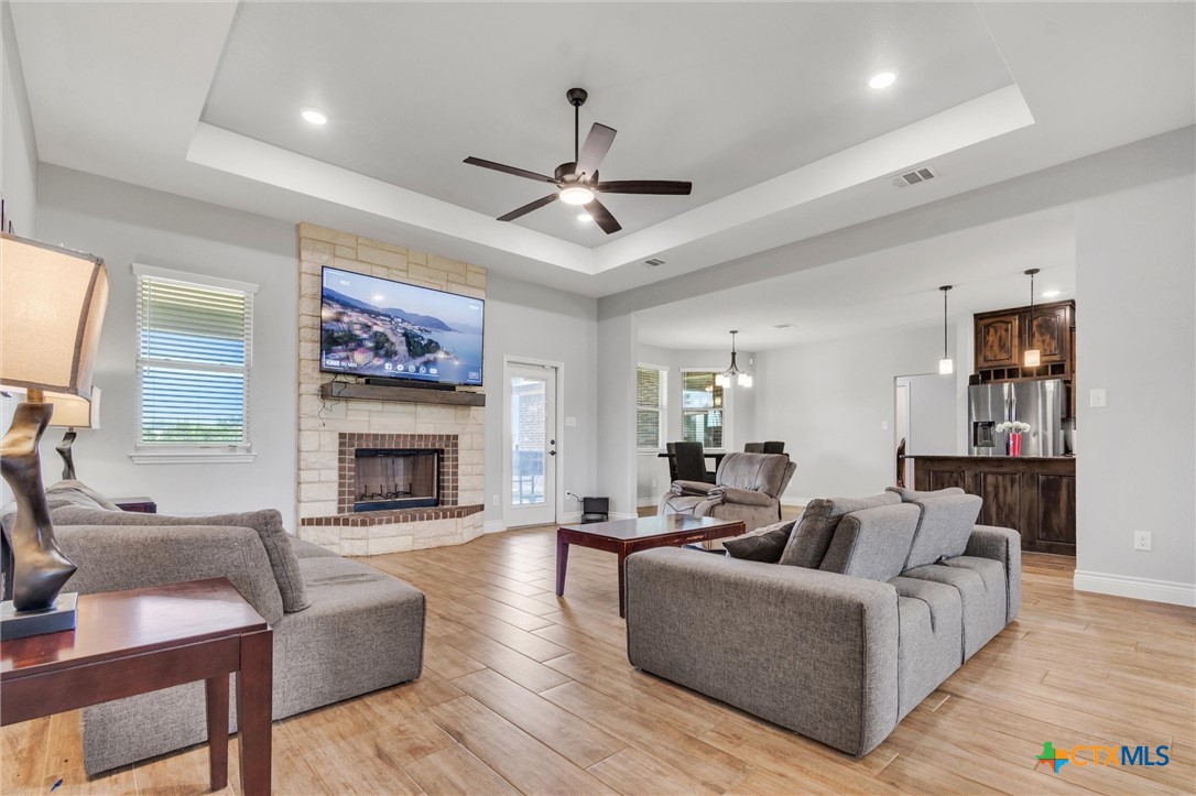 3919 Gracey Lane Kempner, TX 76539 - Photo 10 of 44 a living room with furniture a fireplace and a ceiling fan