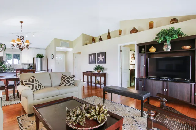 a kitchen with kitchen island a counter top space cabinets and stainless steel appliances