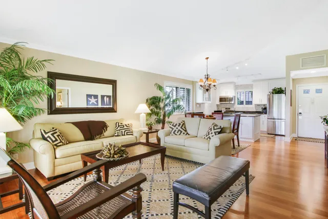 a living room with furniture tv and wooden floor