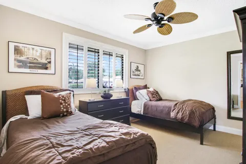 a bedroom with bed and a chandelier