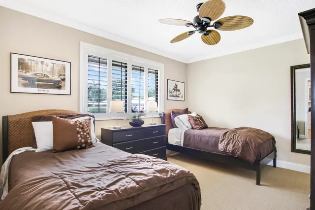 a bedroom with bed and a chandelier