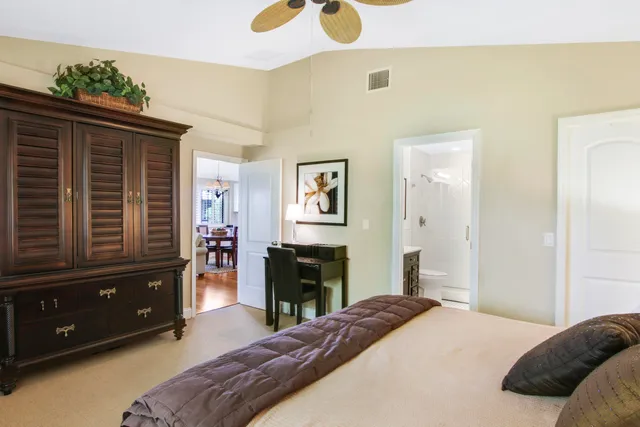 a bedroom with a bed and dresser with mirror