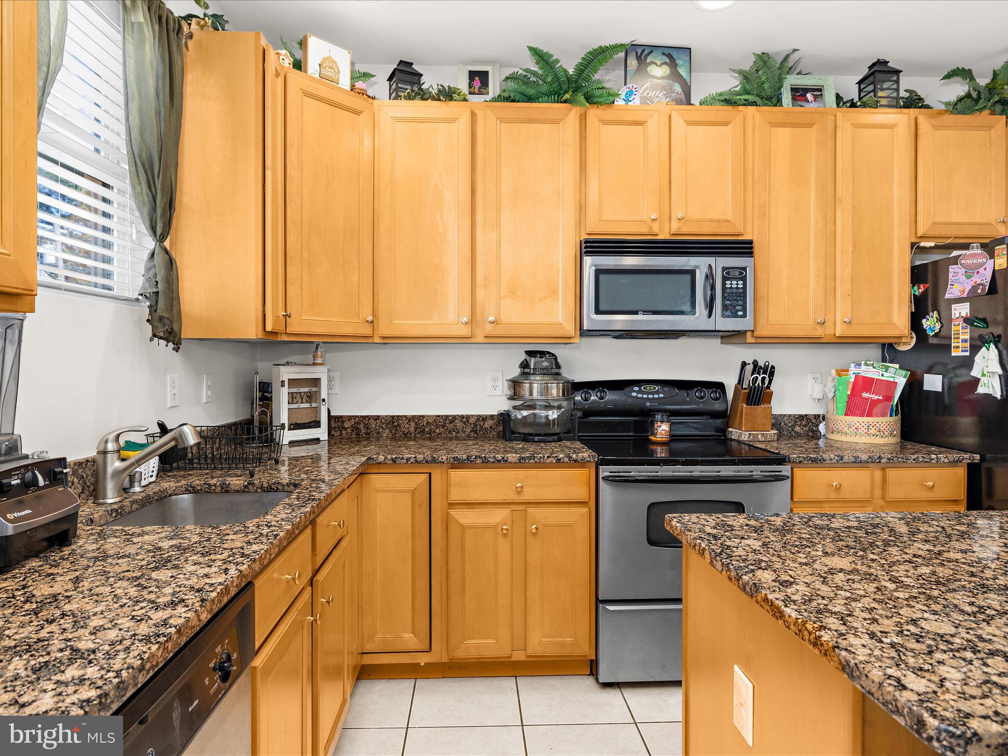 166 Meadow Road Pasadena, MD 21122 - Photo 12 of 47 a kitchen with stainless steel appliances granite countertop a stove a sink and a microwave