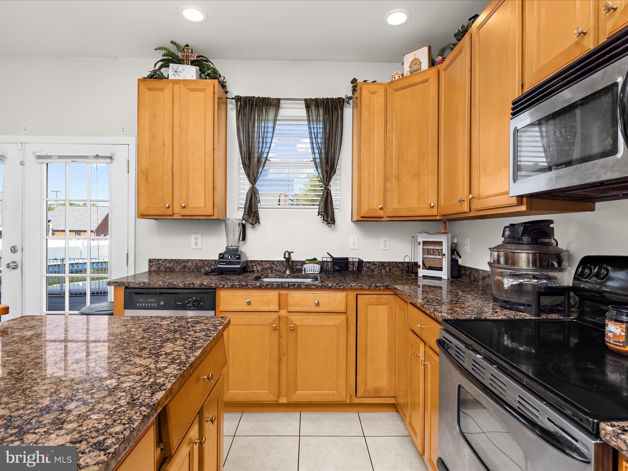 166 Meadow Road Pasadena, MD 21122 - Photo 14 of 47 a kitchen with stainless steel appliances granite countertop a sink a stove cabinets counter space and a window