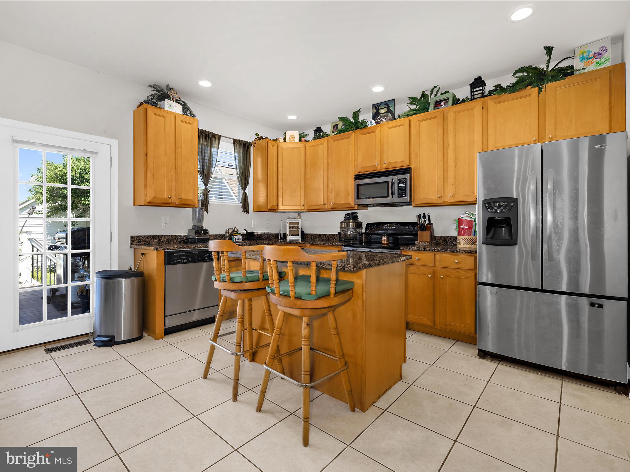 166 Meadow Road Pasadena, MD 21122 - Photo 17 of 47 a kitchen with stainless steel appliances granite countertop a stove a sink and a refrigerator