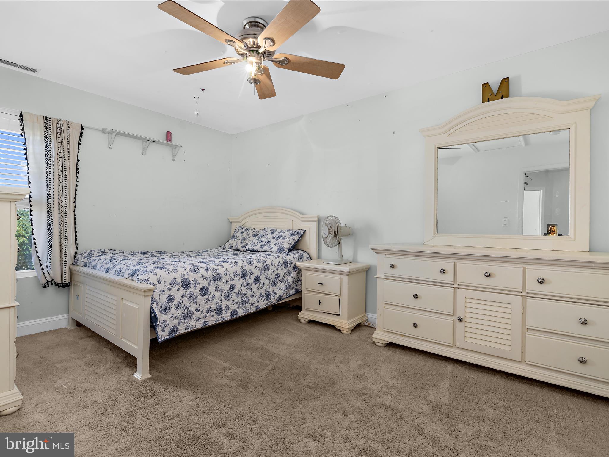166 Meadow Road Pasadena, MD 21122 - Photo 22 of 47 a bedroom with a bed and a chandelier fan