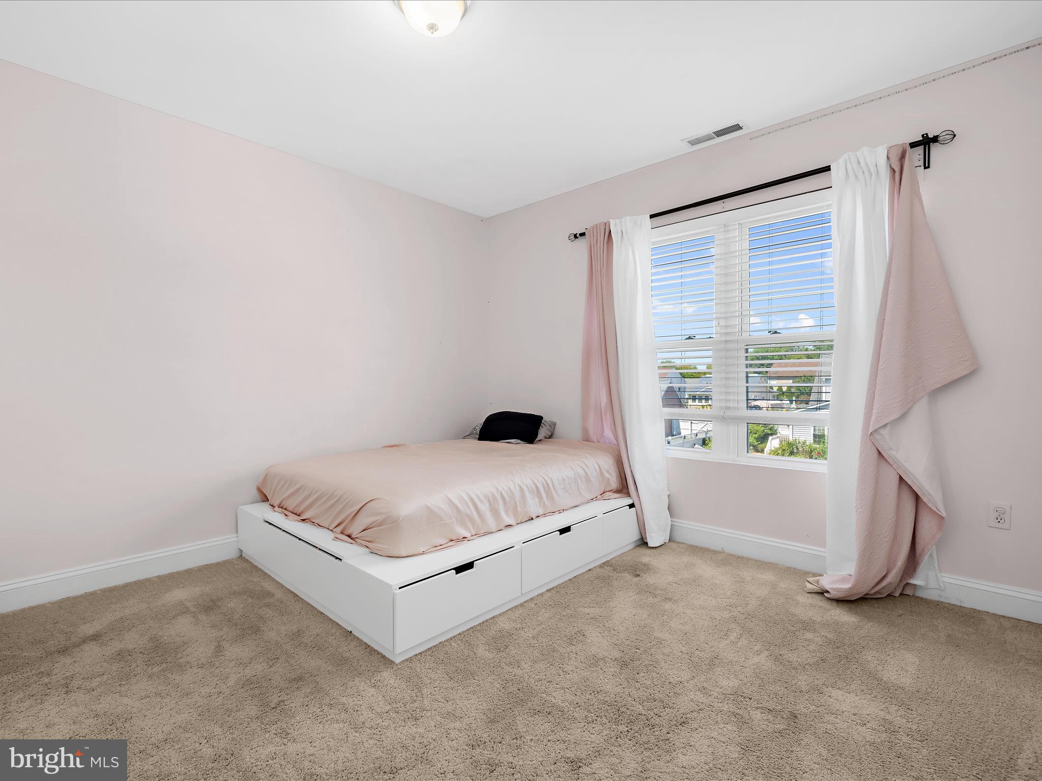 166 Meadow Road Pasadena, MD 21122 - Photo 26 of 47 a living room with a bed furniture and a window