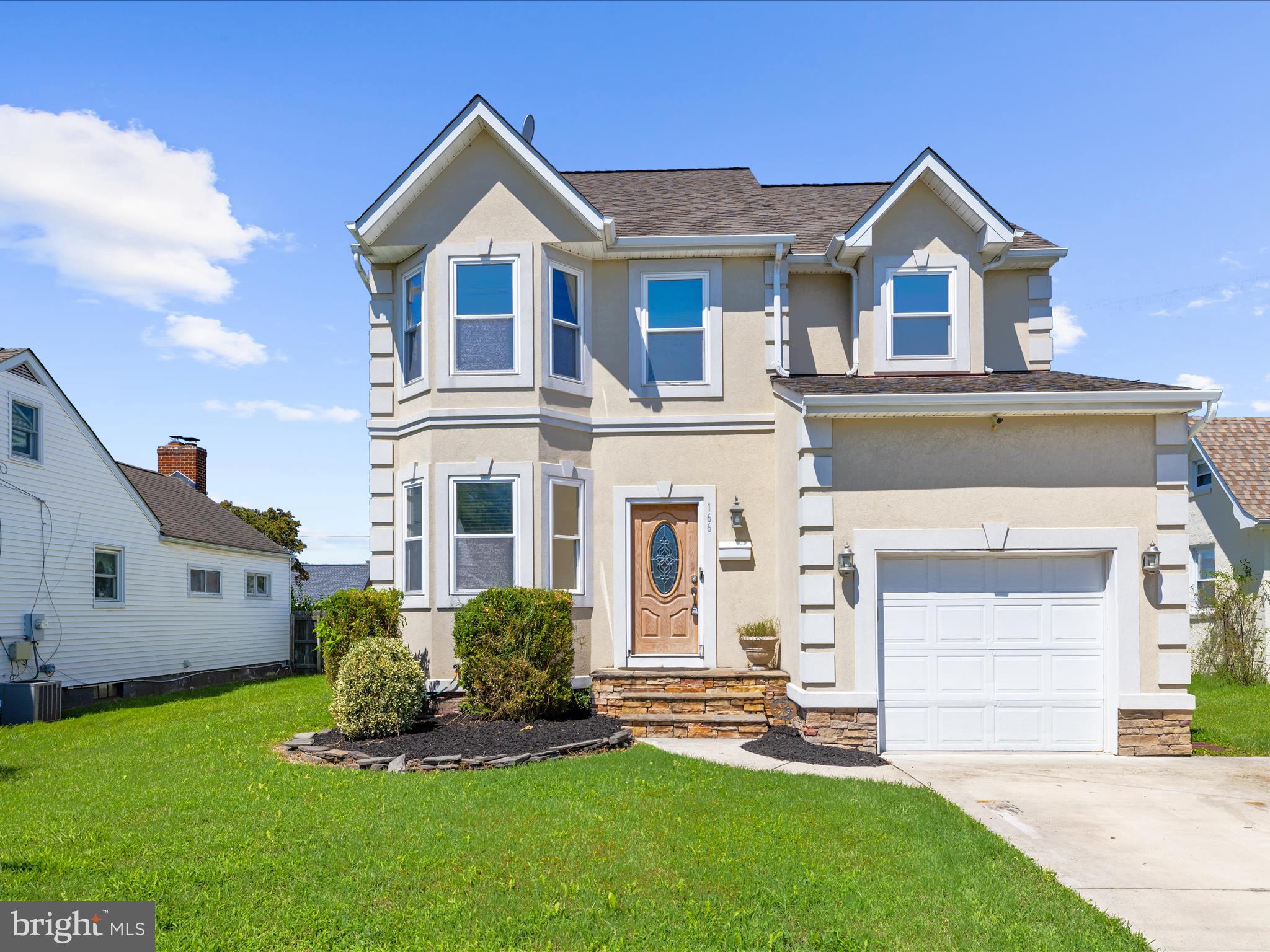 166 Meadow Road Pasadena, MD 21122 - Photo 4 of 47 a front view of a house with a yard and garage