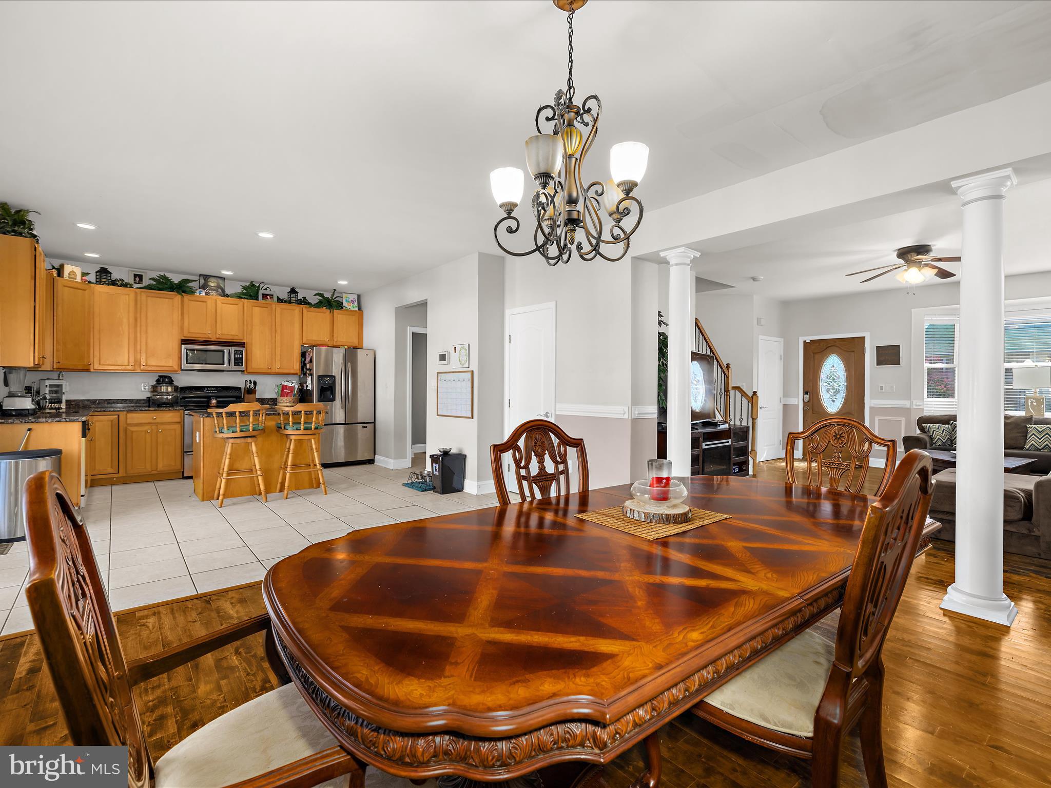 166 Meadow Road Pasadena, MD 21122 - Photo 9 of 47 a dining room with furniture a chandelier and wooden floor