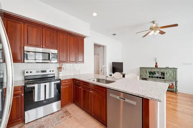 a kitchen with stainless steel appliances granite countertop a sink stove and refrigerator