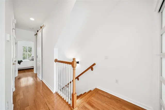 a view of a hallway with wooden floor and entryway