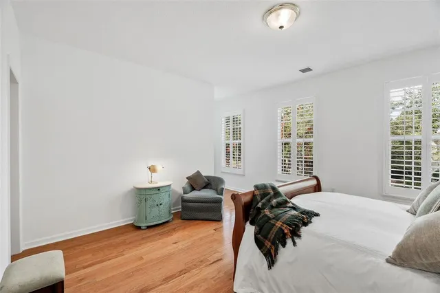 a bed room with couch and a window