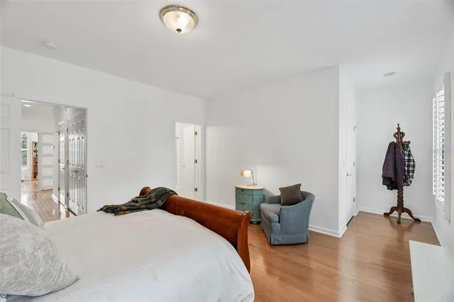 a bedroom with bed and wooden floor