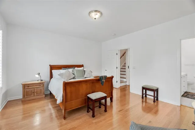 a bedroom with furniture and wooden floor
