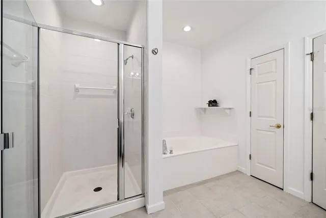 a bathroom with a bathtub and a shower