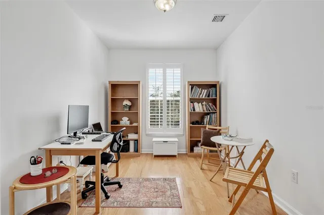 a work room with furniture and wooden floor