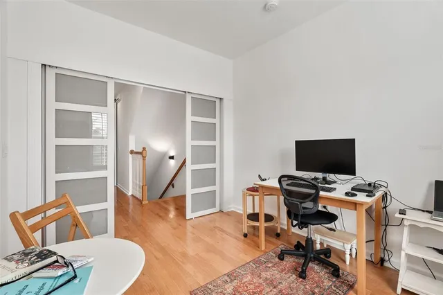 a view of a workspace with furniture and a window