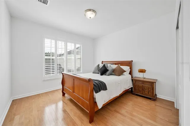 a bed sitting in a bedroom next to a window