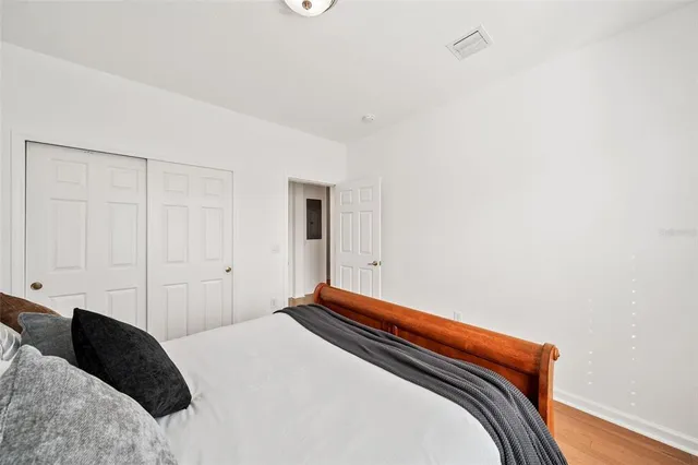 a bedroom with a bed and a lamp