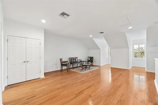 a view of a room with furniture and wooden floor