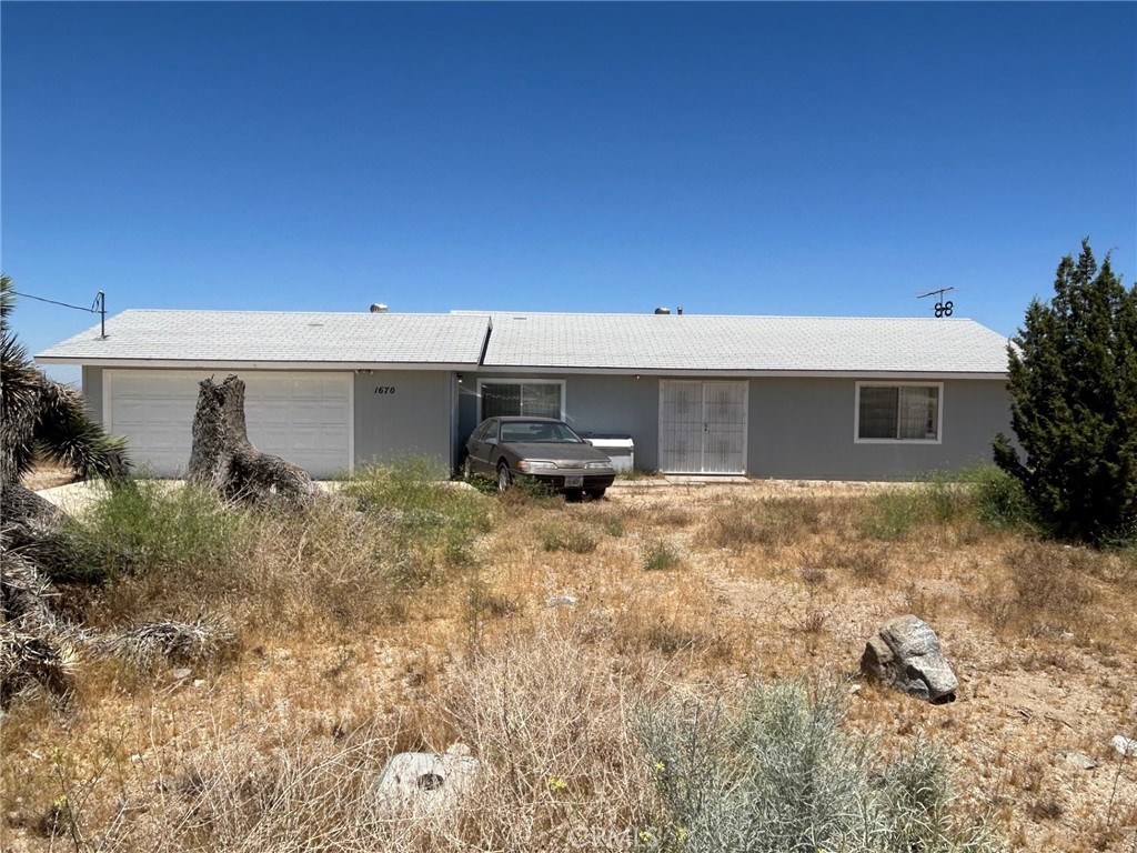 1670 Locust Road Pinon Hills, CA 92372 - Photo 1 of 1 a backyard of a house with yard and garage