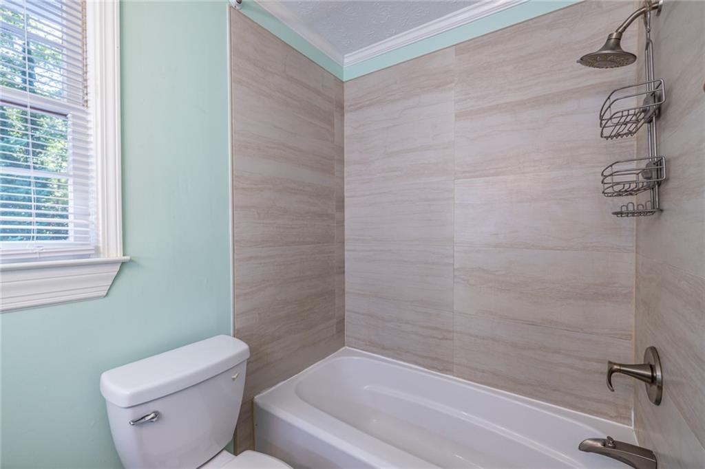 1465 Pounds Road Southwest Lilburn, GA 30047 - Photo 16 of 30 a bathroom with a toilet and a shower