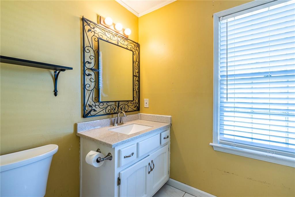 1465 Pounds Road Southwest Lilburn, GA 30047 - Photo 22 of 30 a bathroom with a sink and a mirror